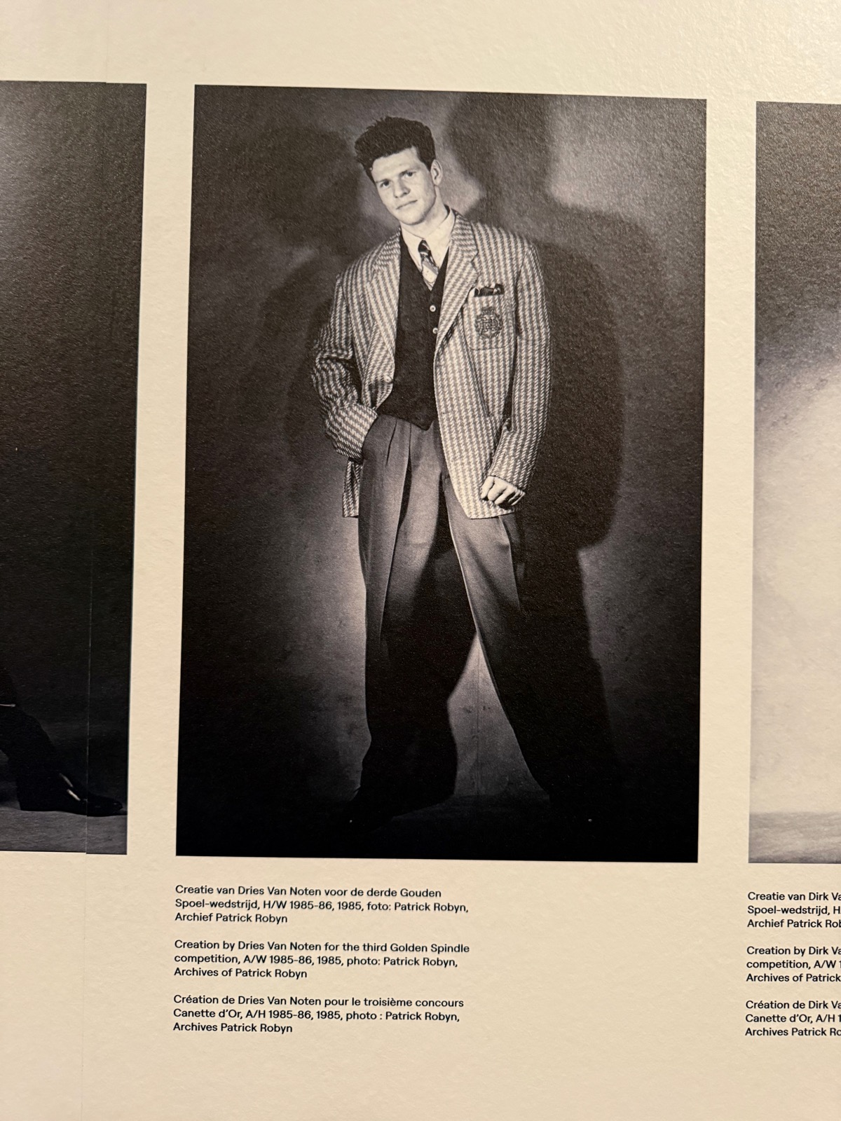 Archive press photograph of a model in a checked Dries Van Noten suit for the third Golden Spindle competition, 1985.