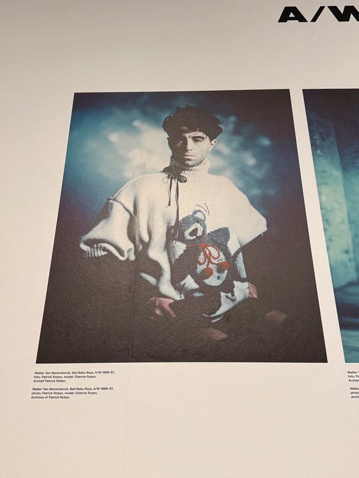 Archive press photograph for Walter Van Beirendonck's Bad Baby Boys, a model in a white knit holding a toy.