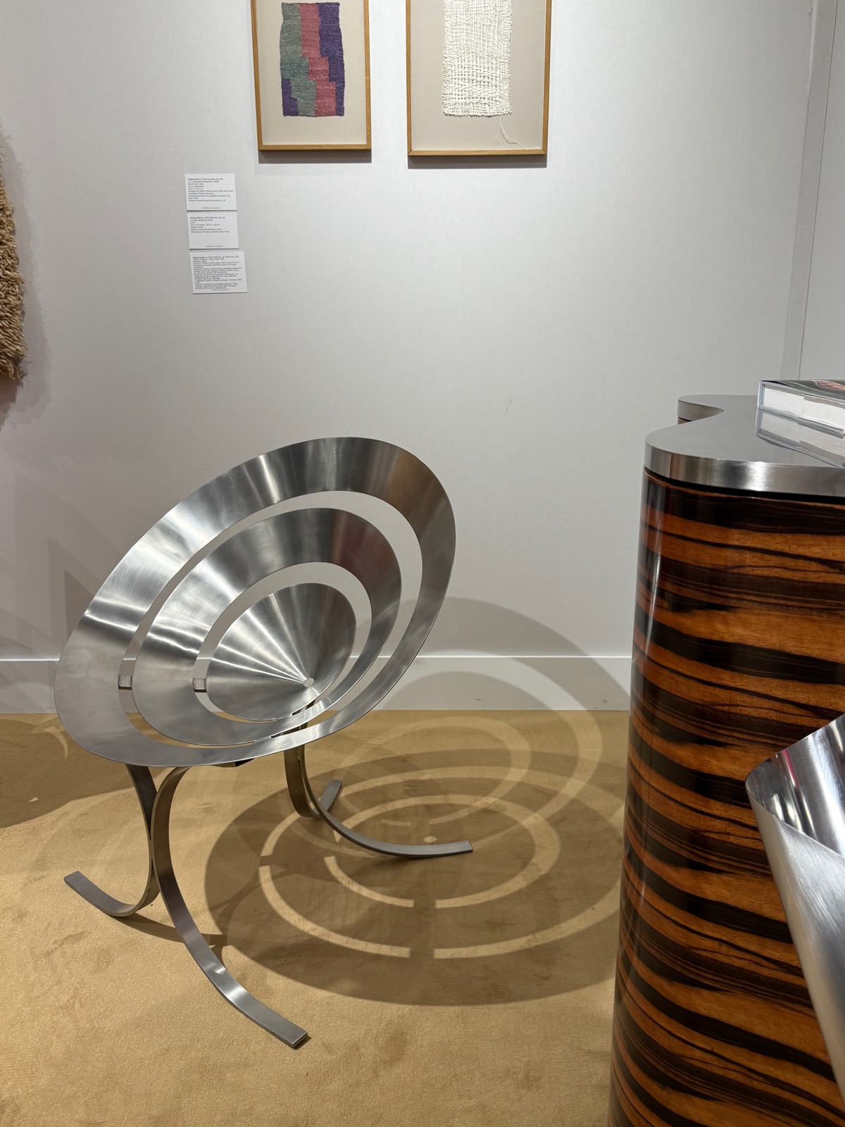 Maria Pergay's stainless-steel Ring Chair, concentric polished rings forming the seat, on curved steel legs.
