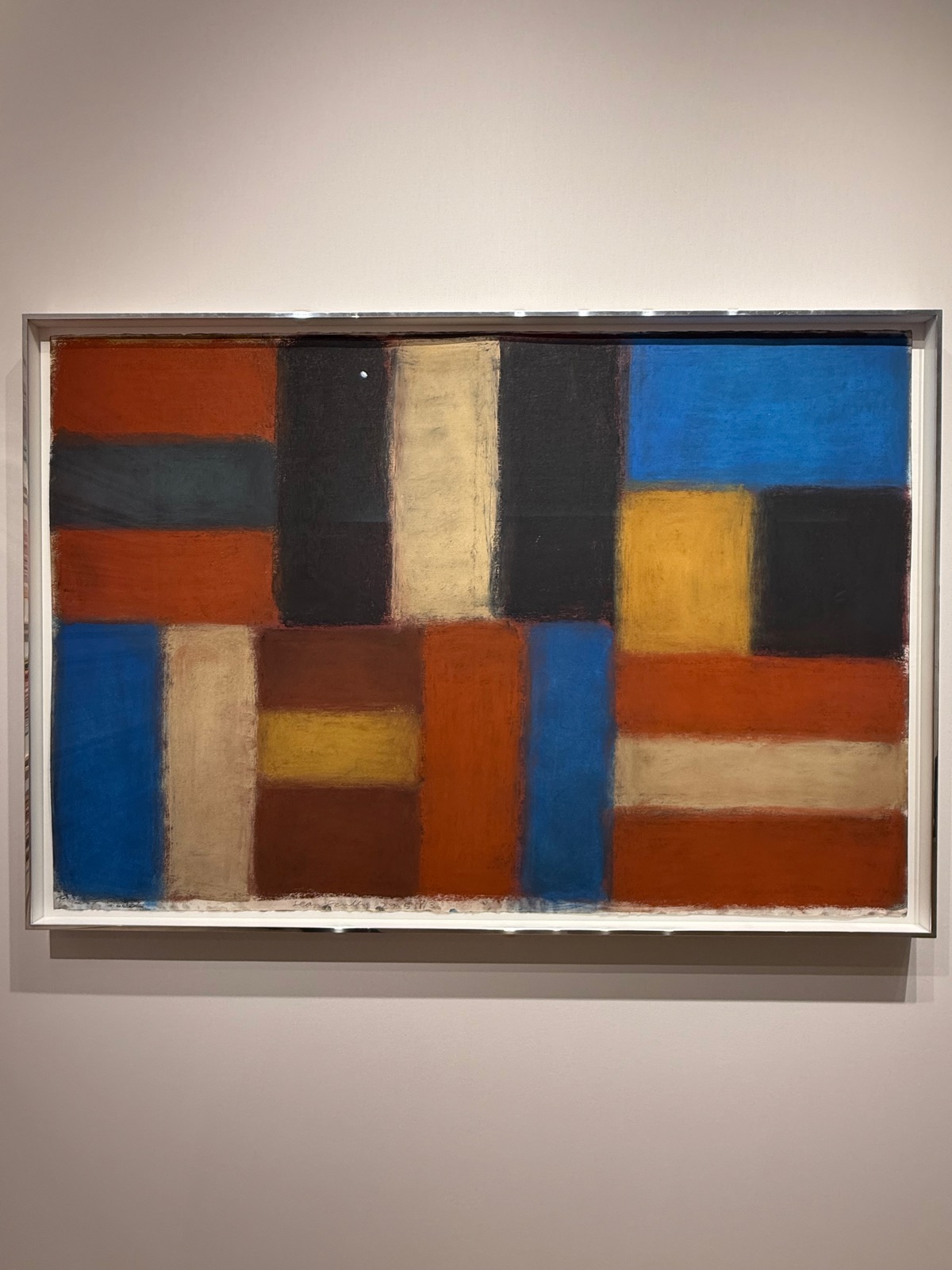 Sean Scully's 2013 pastel: a grid of soft-edged blocks in rust, black, blue, ochre and cream.