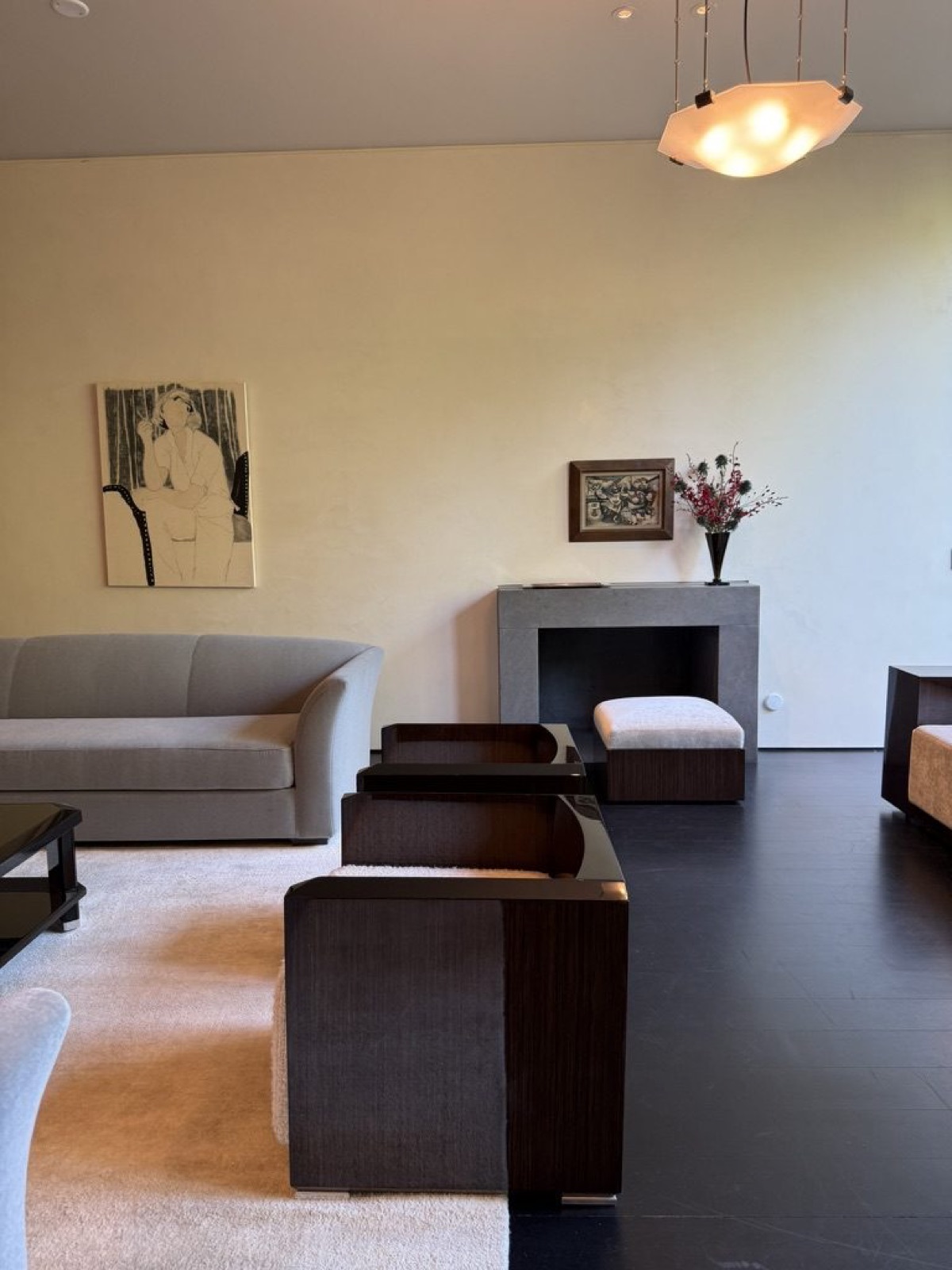 Assembler I installation view: lacquer cube armchairs, a curved sofa and a faceted glass pendant.